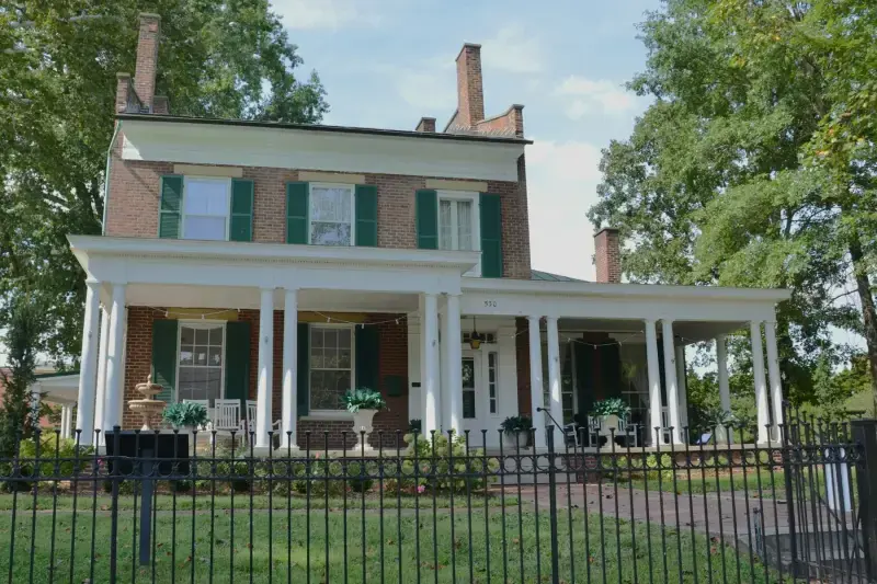 Brick house with a white two-story columned porch