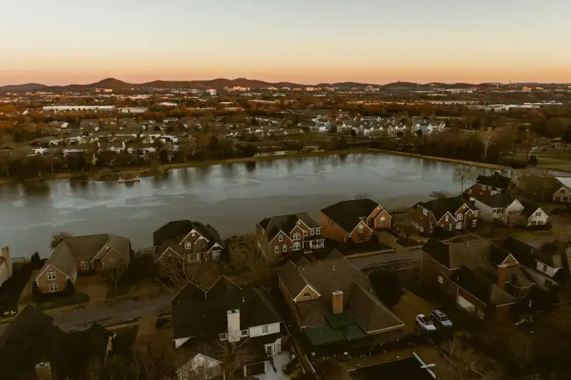 Aerial view of a lakeside subdivision at dusk