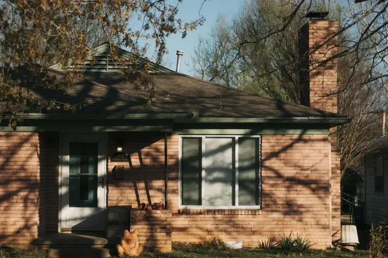 Single-story brick ranch house in late-afternoon light